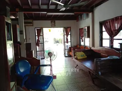 Charming rustic living room with wooden beams and cozy seating area.