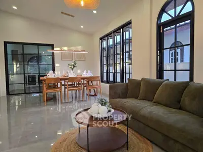 Elegant living room with modern dining area and stylish decor