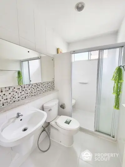 Modern bathroom with sleek fixtures and glass shower enclosure