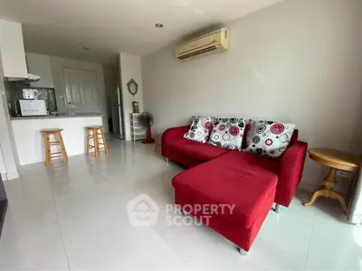 Modern living room with red sofa and open kitchen layout
