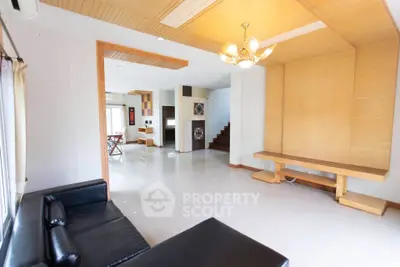 Spacious modern living room with elegant lighting and open layout, perfect for family gatherings.