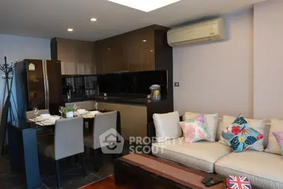 Modern open-layout kitchen and living room with stylish decor and dining area.