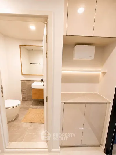 Modern bathroom with sleek cabinetry and elegant fixtures in a contemporary apartment.