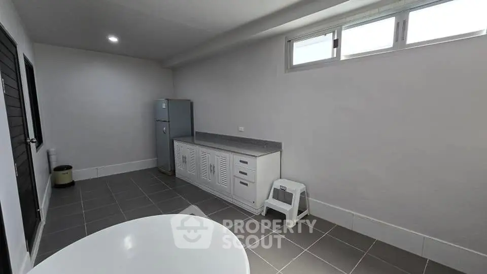 Spacious utility room with modern appliances and ample storage space