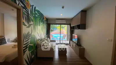 Stylish living room with tropical wallpaper and pool view, perfect for relaxation.