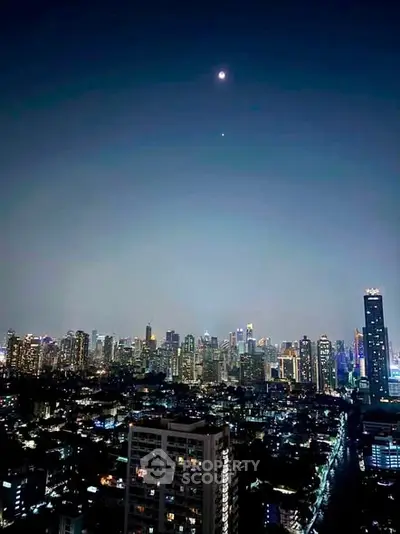 Stunning city skyline view at night with illuminated skyscrapers and a clear sky.