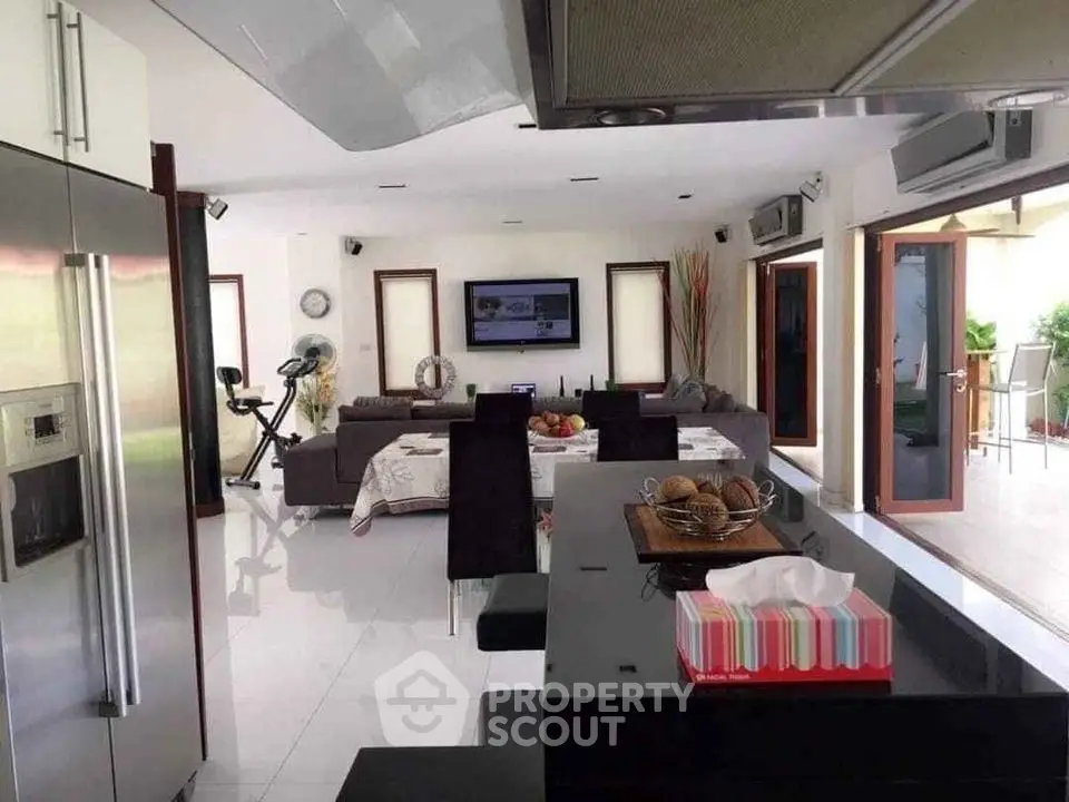 Spacious modern living room with open kitchen and exercise area