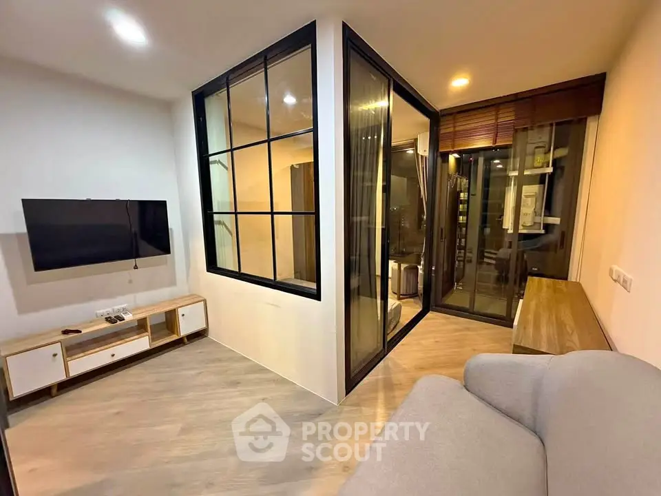 Modern living room with glass partition and cozy balcony view