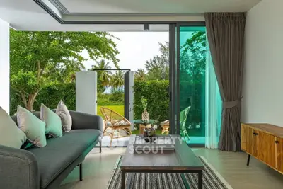Modern living room with open view to lush garden and stylish furniture