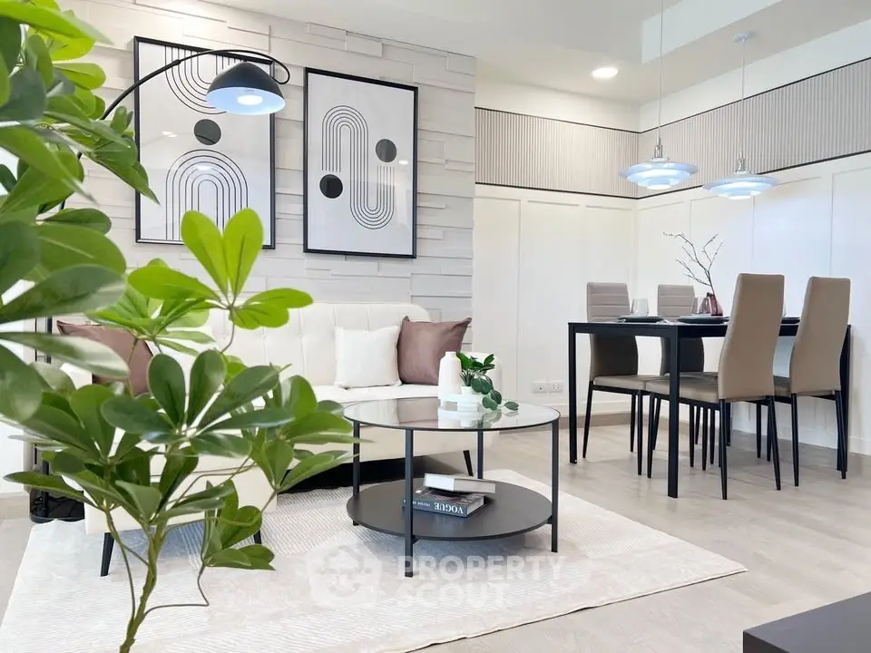 Modern living room with stylish decor and dining area, featuring contemporary furniture and elegant lighting.