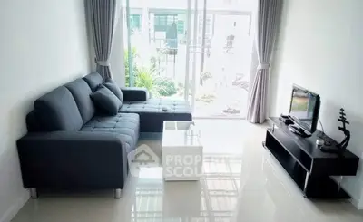 Modern living room with sleek furniture and large window view