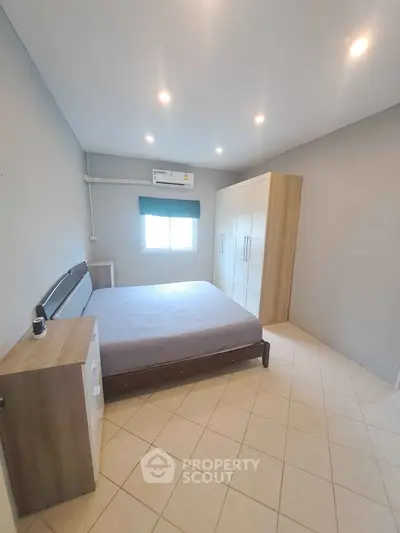 Spacious bedroom with modern furnishings and ample natural light