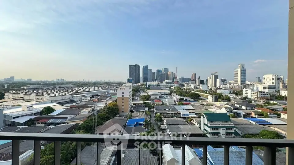 Stunning cityscape view from a high-rise balcony overlooking urban skyline and residential area.