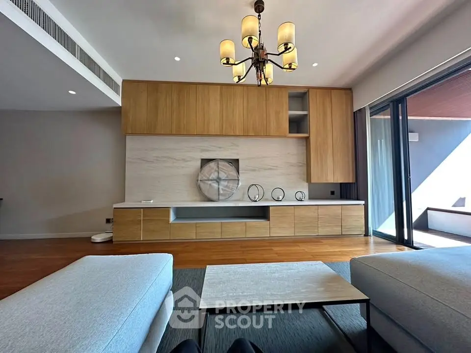 Luxurious modern living room with elegant chandelier and spacious seating area