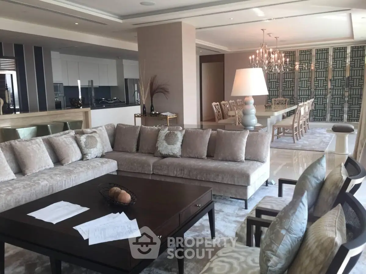 Luxurious open-plan living and dining area with elegant decor and plush seating.