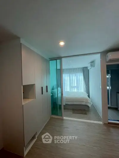 Modern bedroom with sliding glass door and ample natural light