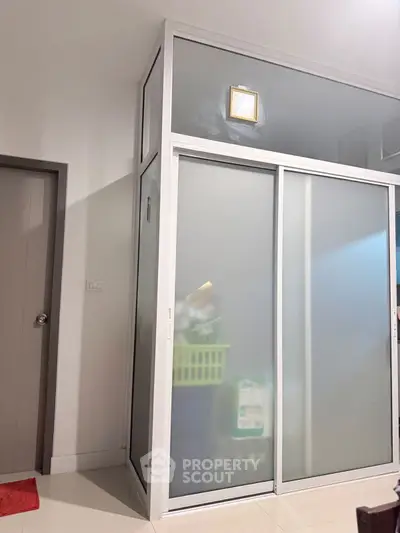 Modern storage room with frosted glass sliding doors and sleek design