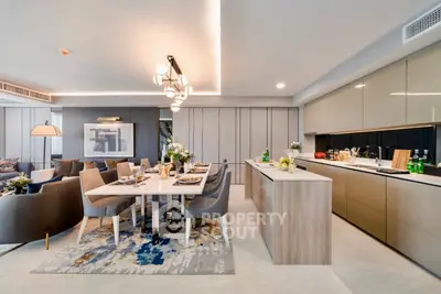 Luxurious open-plan kitchen and dining area with modern decor and elegant lighting.