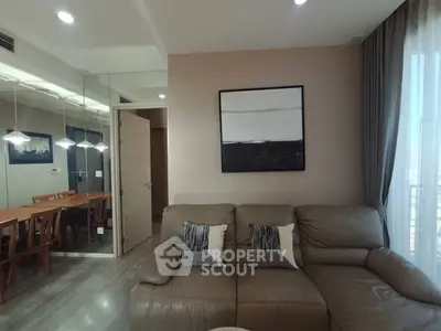 Modern living room with stylish decor and dining area in open layout apartment.