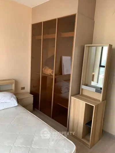 Modern bedroom with sleek wardrobe and stylish vanity in a cozy apartment.