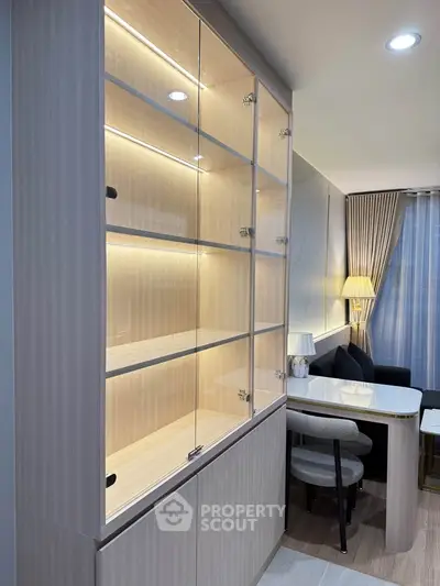 Modern living room with elegant glass cabinet and cozy seating area
