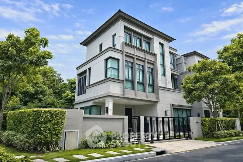 Luxurious modern house with sleek architecture and lush greenery in a serene neighborhood.