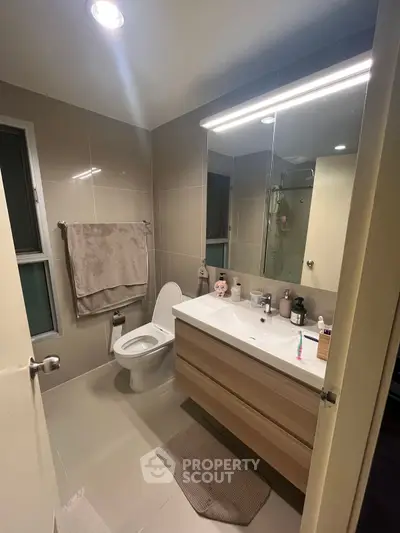 Modern bathroom with sleek fixtures and large mirror