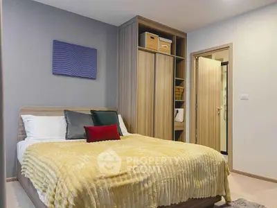 Cozy bedroom with modern decor and built-in wardrobe in stylish apartment.