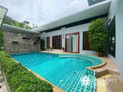 Luxurious private pool with modern design and lush greenery in a serene residential setting.