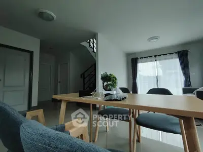 Spacious modern living room with natural light and stylish furniture