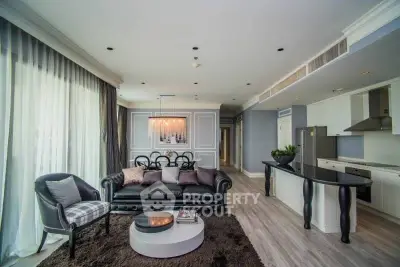 Luxurious open-plan living room with elegant decor and modern kitchen