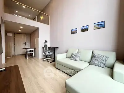 Modern living room with high ceiling and stylish decor in a spacious apartment.