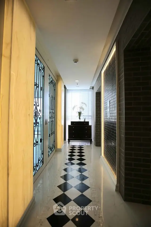 Elegant hallway with checkered floor and decorative lighting in modern building
