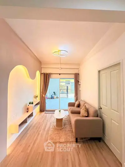 Stylish living room with modern lighting and cozy seating area, perfect for relaxation.