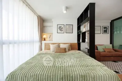 Modern bedroom with stylish decor and cozy ambiance in a contemporary apartment.