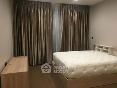 Spacious bedroom with elegant curtains and modern furniture