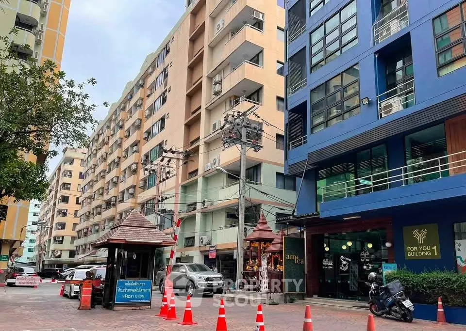 Modern urban apartment buildings with vibrant facades and street view.