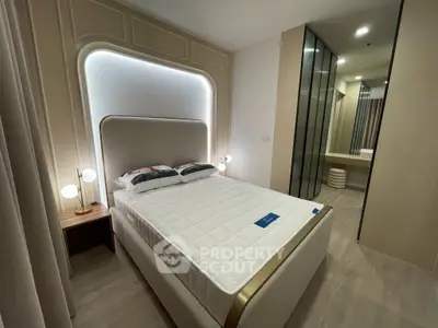 Luxurious bedroom with modern design and ambient lighting, featuring a comfortable bed and elegant decor.