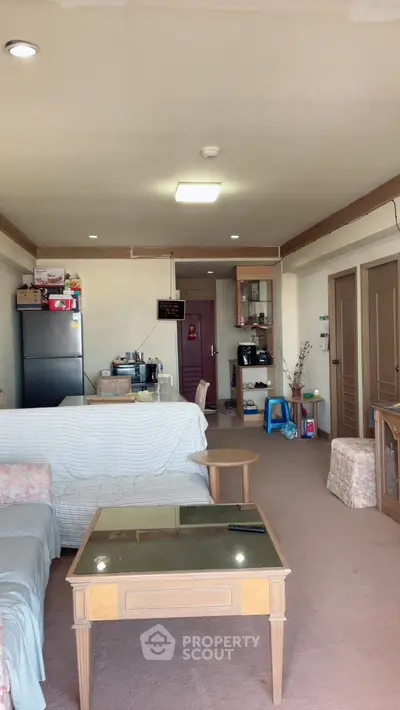 Spacious living room with cozy seating and open kitchen layout.