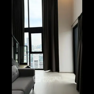 Spacious modern living room with floor-to-ceiling windows and city view