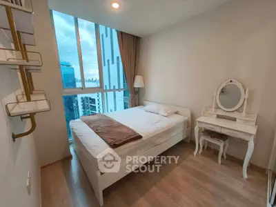 Modern bedroom with city view, featuring a cozy bed and elegant vanity table.