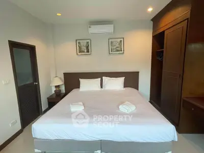 Spacious bedroom with cozy bed and modern decor in a stylish apartment.