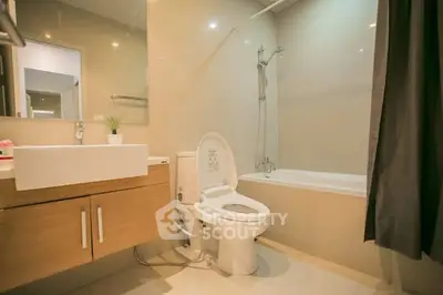 Modern bathroom with sleek fixtures and bathtub in a contemporary home.