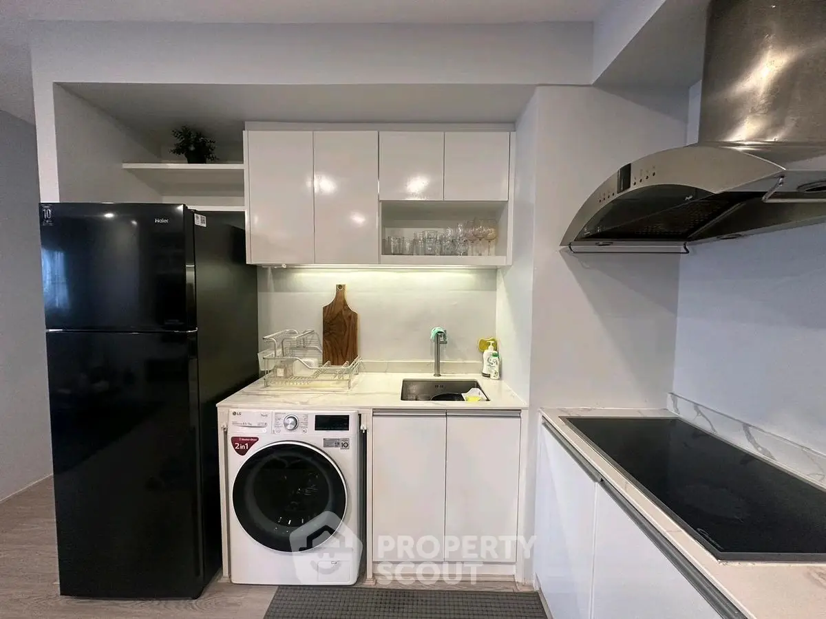 Modern kitchen with sleek appliances and compact design