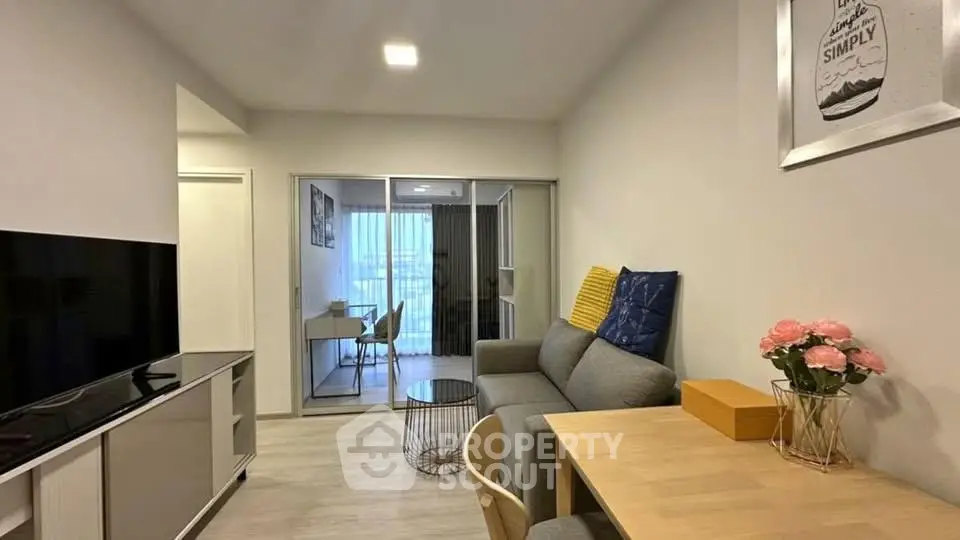 Modern living room with cozy seating and stylish decor in a contemporary apartment.