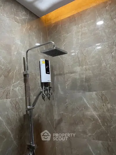 Luxurious bathroom with modern rain shower and elegant marble tiles