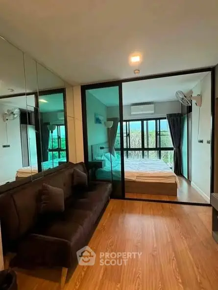 Modern apartment with glass partitioned bedroom and stylish living area