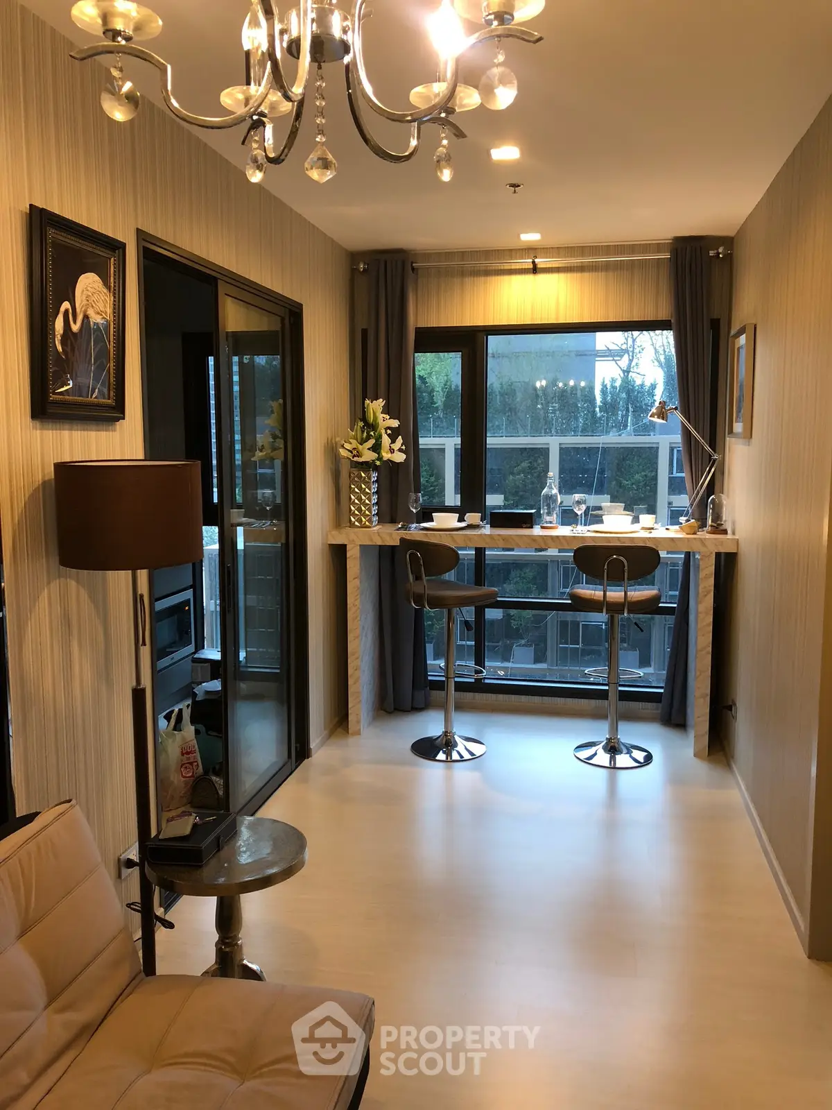 Stylish modern living room with elegant decor and balcony view.