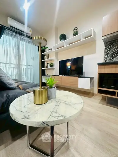 Modern living room with stylish decor and natural light, featuring a marble coffee table and sleek TV unit.