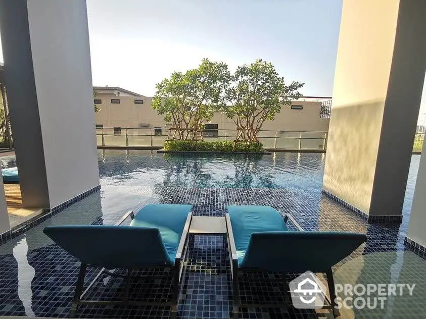 Luxurious poolside view with modern lounge chairs and serene ambiance